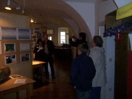 Gail and Tom Spencer have their picture taken in front of the story of 